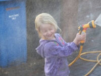 Leia washing Daddy’s car and getting soaked.